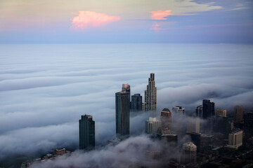 View from Willis Tower or Sears Building in Chicago with Fog Clouds Rolling in on the City Buildings