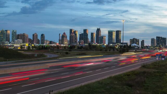 Looking west down highway 403 in downtown Mississauga, Ontario, Canada. Shot in time lapse from day to night, tilting down. 2016.