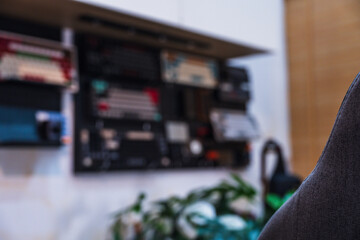 Modern home office desk setup with American Independence Day theme, including monitors displaying US flag wallpaper, bonsai tree, microphone, and warm cozy lighting ambiance.