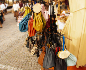 Bright handmade leather waist bags at an exhibition at the medieval street market in Bavaria