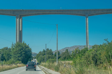 Concrete viaduct bridge crossing forest landscape