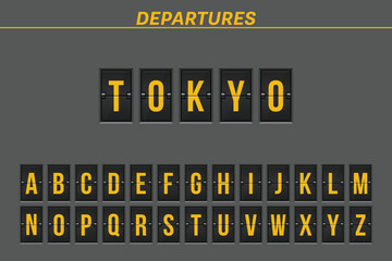 Airport-style departure board showing the destination "Tokyo" with the full alphabet below. The display is in black and yellow with the word "DEPARTURES" on top.