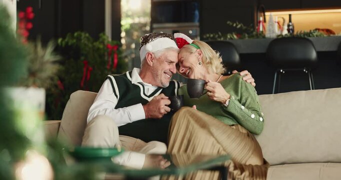 Christmas, coffee and toast with old couple on sofa in living room of home for festive celebration. Cheers, hug and love with happy senior people in apartment for bonding, holiday or vacation