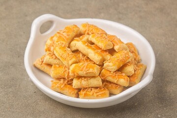 Kue Kastengel. Kaasstengels (Dutch, kaas, cheese; stengel, stem) are pastries made from a mixture of wheat flour, eggs, margarine and grated cheese.