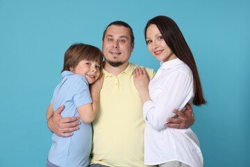 Fototapeta premium Portrait of happy family on light blue background