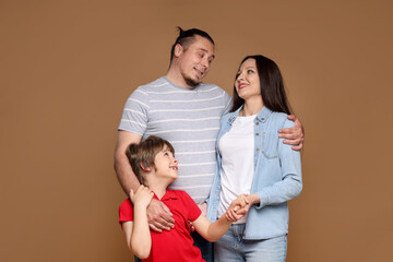 Portrait of happy family on brown background
