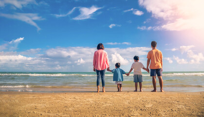 Asian family vacation holiday on the beach in the sunset