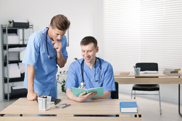 Fototapeta premium Medical students in uniforms studying together at university