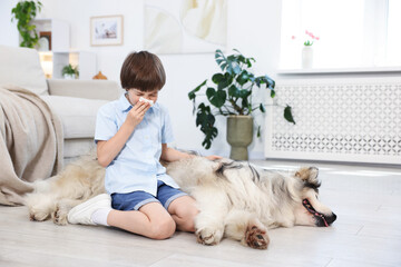 Boy suffering from allergy with her dog at home