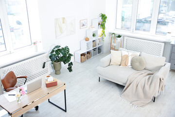 Desk with laptop in stylish room, above view