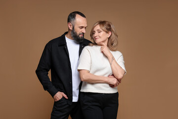 Portrait of lovely couple on brown background