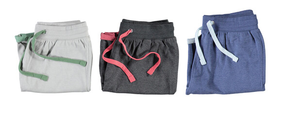 Folded grey and blue shorts with colourful laces. Isolated image on a white background. Nobody.