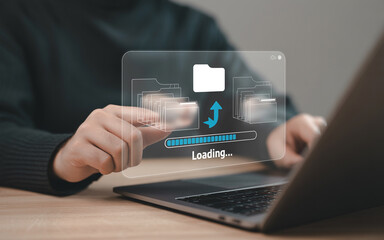A person uploads or downloads files using laptop with a loading bar and folders on the digital interface.