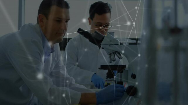 After partner tapping tube, lab scientists examining slide as digital overlay pulsing for analysis - Powered by Adobe