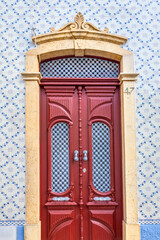 Old red door in downtown of Albufeira, Portugal