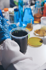 Scientist pipetting medical samples into microplate in laboratory