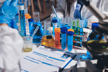Scientist pipetting medical samples into microplate in laboratory