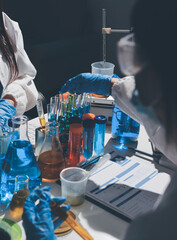 Scientist pipetting medical samples into microplate in laboratory