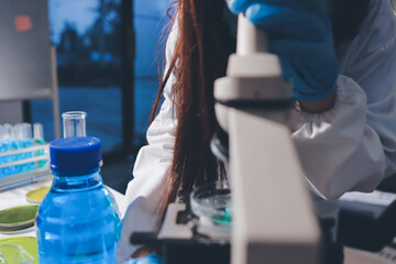 Scientist pipetting medical samples into microplate in laboratory