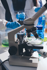 Scientist pipetting medical samples into microplate in laboratory