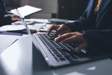 Group of business women working on a financial data expenses document.