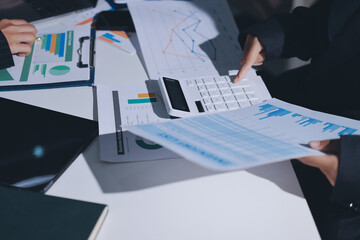 Group of business women working on a financial data expenses document.