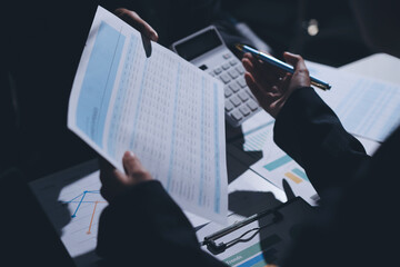Group of business women working on a financial data expenses document.