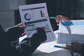 Group of business women working on a financial data expenses document.
