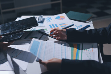 Group of business women working on a financial data expenses document.