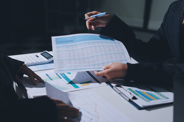Group of business women working on a financial data expenses document.