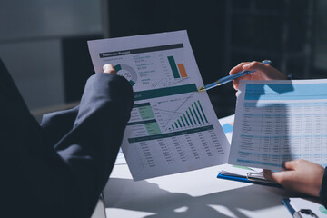 Group of business women working on a financial data expenses document.