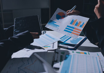 Group of business women working on a financial data expenses document.