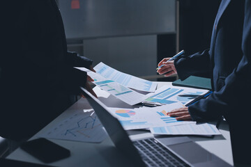 Group of business women working on a financial data expenses document.