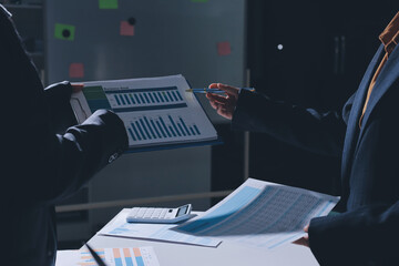 Group of business women working on a financial data expenses document.