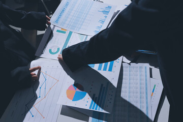 Group of business women working on a financial data expenses document.
