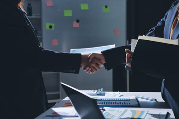 Happy two Asian business man and woman handshake to congratulate success. Successful Asian business people working together team.