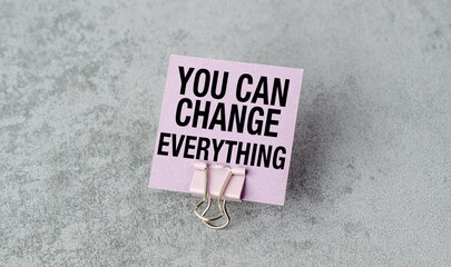 A pink card with the words You Can Change Everything written on it