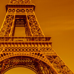 close up of Eiffel Tower in Paris colored in golden color