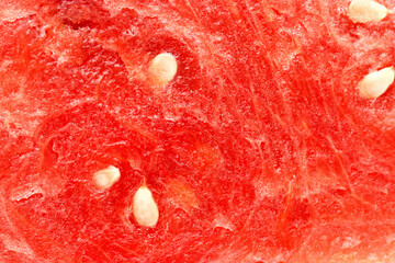 Vibrant red watermelon slice with seeds showcased in bright sunlight during summer months at a...