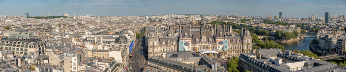 Fototapeta na wymiar Paris, France - 06 28 2025: Panoramic view of Paris City Hall and East Paris behind from rooftop of Saint-Jacques Tower and gargoyles in front