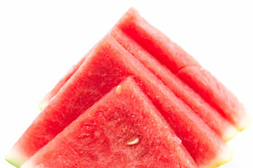 Fresh watermelon slices stacked artistically on a clean white background showcasing vibrant colors...