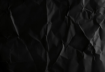 Crumpled black paper texture background creating dark abstract backdrop