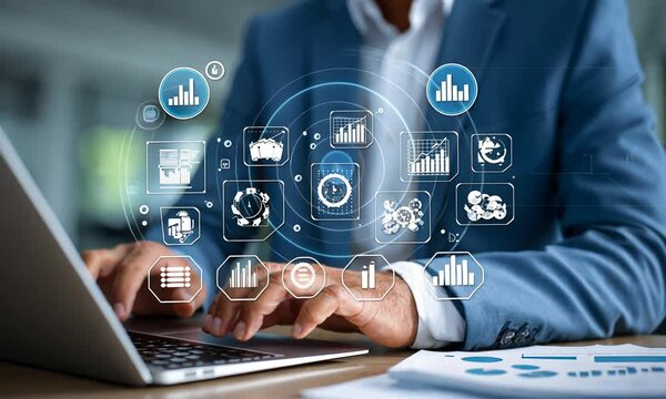 Businessperson working on a laptop with data visualizations, in a modern office setting, for data analytics usage