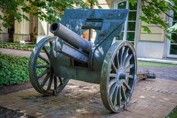 Antique Cannon in a Park. Old Artillery weapon gun mortar howitzer. Military Warsaw
