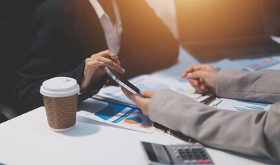 Close up of Business team analyzing income charts and graphs with modern laptop computer. Business...