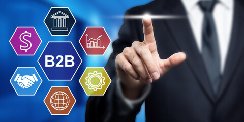 B2B Solutions: Businessman Touching Virtual Interface Displaying Business Icons for Finance, Global Trade, and Technology Solutions
