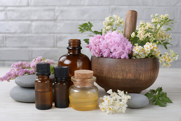 Amber bottles with floral aromatherapy essential oils