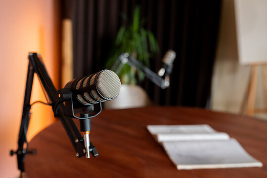 Detailed setup of a podcast recording space featuring microphones and an inviting atmosphere for discussions