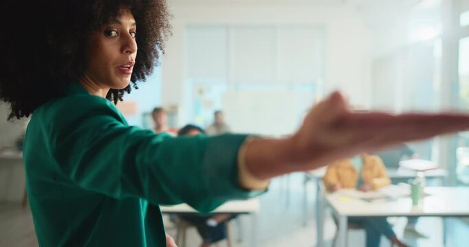 Education, explain and presentation with teacher in classroom for development or learning. College, school and university with woman educator speaking to students for course, lecture or lesson