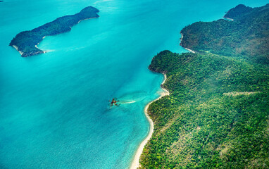 Aerial view of submerged reefs (green color) and surface clear waters (blue color) at Great Barrier...